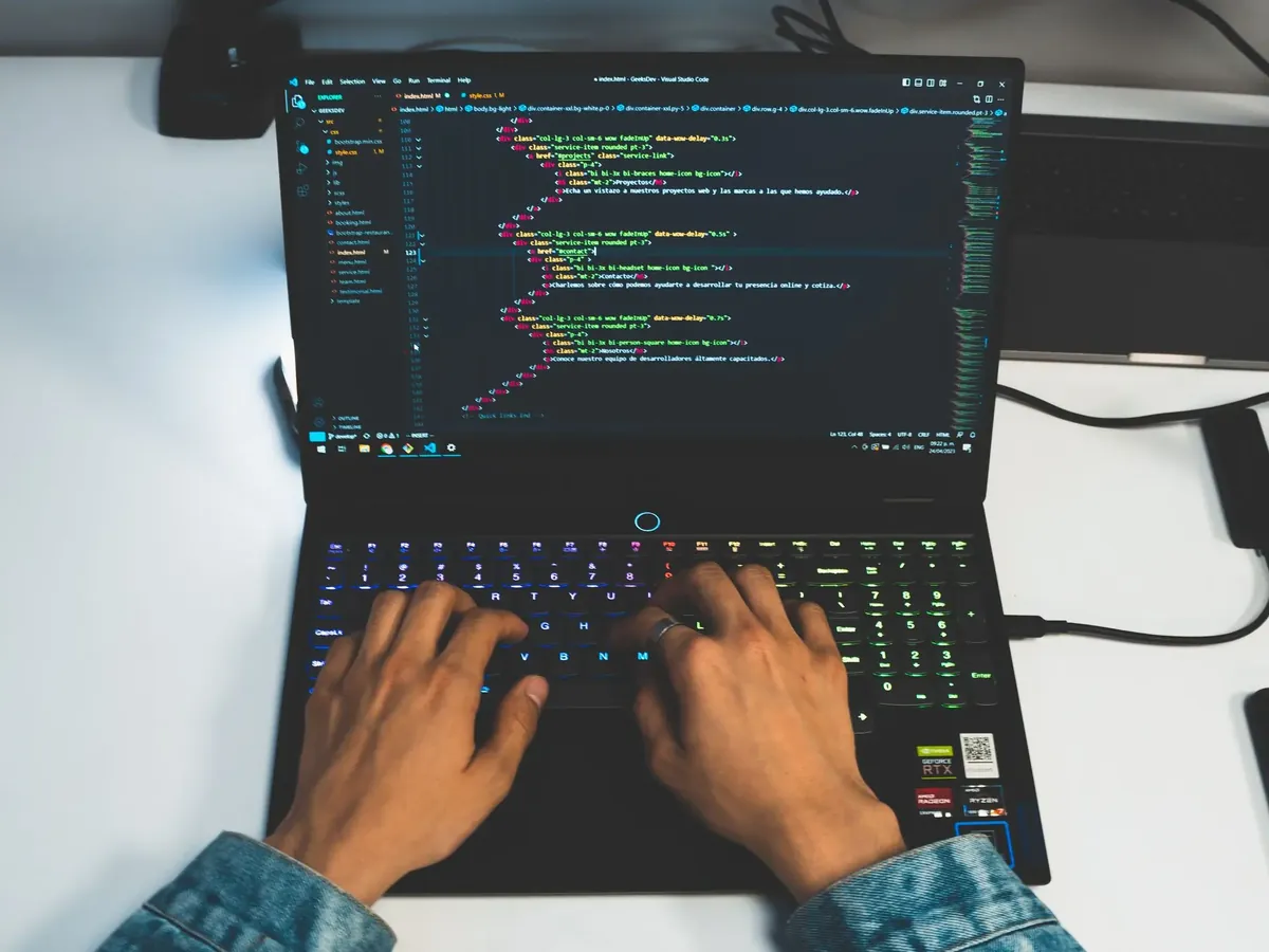 Hands coding on a laptop